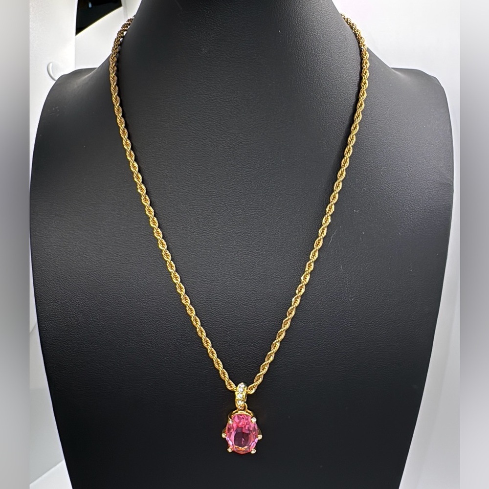 Nolan Miller large pink glass pendant on a gold tone rope chain. Signed.
